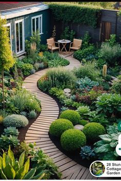 a garden with lots of green plants and flowers on it, along with a wooden walkway