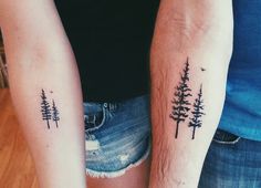 two people with matching tattoos on their arms