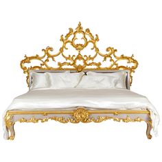 an ornate gold and white bed frame with pillows on it's sides, against a white background