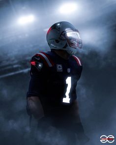 a football player wearing a uniform and helmet in the fog with lights on behind him