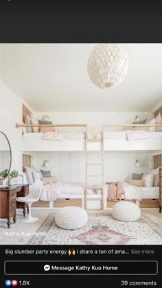 a white bedroom with bunk beds and pillows on the bottom floor, in front of a mirror