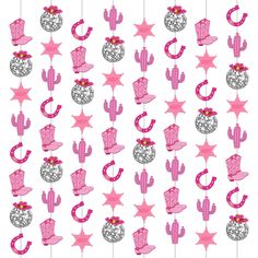 pink and silver decorations hanging from strings with stars, hats, and cactuses on them