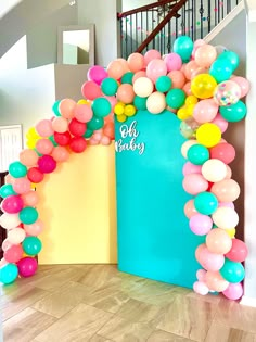 the entrance to a baby's first birthday decorated with balloons