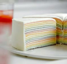 a slice of rainbow cake on a white plate