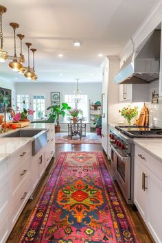 a colorful rug in the middle of a kitchen