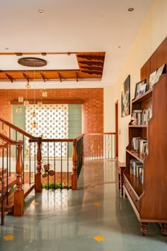 a room that has some books on the shelves in it and a book case next to the stairs