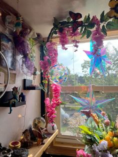 the window is decorated with flowers and fairy wands hanging from it's sides