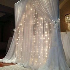 a white canopy with lights on it in the middle of a room