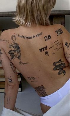 the back of a woman with tattoos on her body