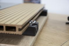 a close up view of the side of a laptop with wood slats on it