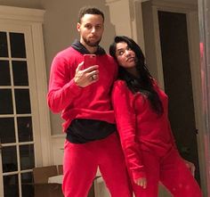 a man and woman dressed in red posing for the camera