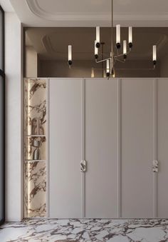 an empty room with marble floors and white cupboards on the wall next to it