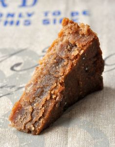 two pieces of cake sitting on top of a white plate covered in chocolate frosting