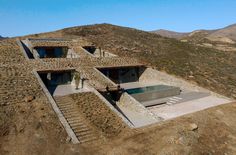 an aerial view of a house in the mountains