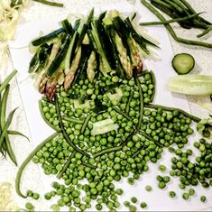 peas, cucumbers and green beans on a cutting board