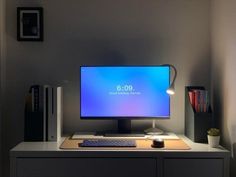 a computer monitor sitting on top of a desk