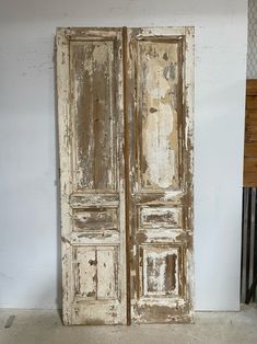 an old wooden door with peeling paint on it