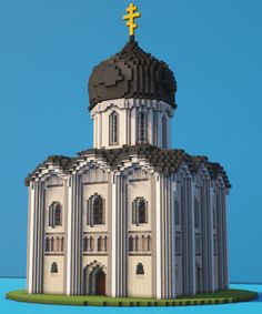 a large white building with a cross on top and a blue sky in the background