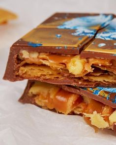 three pieces of chocolate and caramel are stacked on top of each other