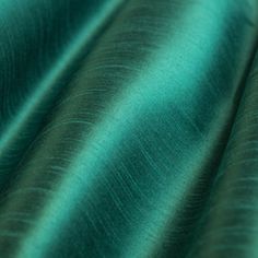 a close up shot of the fabric in teal green color, which is very soft and shiny