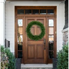 a front door with a wreath on it