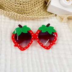 These gorgeous children's sunglasses are the perfect fun summer accessory.  These sunglasses are a gorgeous bright red in the shape of strawberry's with white polka dots all over and a green leaf and brown stem on top. The glasses have a gradual purple lens with UV400 protection. The glasses are plastic for comfortability and durability..  They are such a fun accessory with a retro feel for your little ones this summer.    Suitable for ages 1 Year - 10 Years  ♥ SIZE ♥ in cm * Width - 12.4 cm  * Strawberry Sunglasses, Toddler Summer, Cake Banner Topper, Uv Sunglasses, Leaf Nature, Kids Sunglasses, Summer Accessories, Birthday Cake Toppers, Summer Holiday