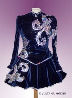 a blue dress with silver sequins on the shoulders and long sleeved sleeves