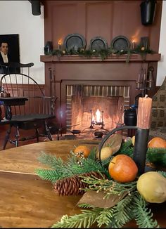 a living room filled with furniture and a fire place next to a mantle covered in pine cones