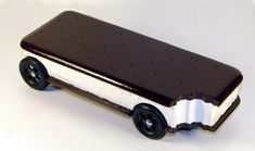 a chocolate and white ice cream truck is shown on a white surface with black wheels