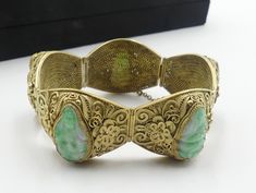 "Old Chinese gold plate silver filigree and carved jade GuanYin bracelet with original, In very good condition. Dates about 1940 's. Measures 7\" ¼ long 1\" wide and 3/8\" thick. ( 185 mm long 22 mm wide 9 mm thick ). Carved jade GuanYin 20 mm x 11 mm, 21 mm x 11 mm. 22mm x 11 mm. Weighs 61.5 gram. Stamped silver. Thanks. This item no shipping to China." Chinese Gold, Carved Jade, Jade Carving, Silver Filigree, Gold Plated Silver, Chain Link Bracelet, Chain Link, Dates, Jade