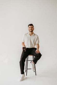 a man sitting on top of a stool