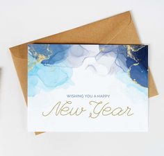 a card with the words wishing you a happy new year written in gold on it