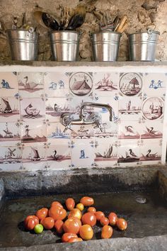 oranges are being washed in an old sink