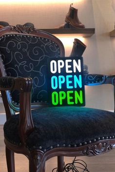 an open sign sitting on top of a chair