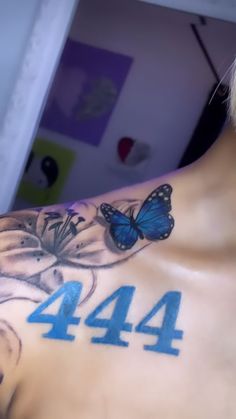 a man with a butterfly tattoo on his back and the number forty four behind him