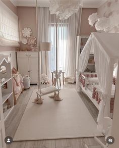 a bedroom with pink walls and white furniture in the room is furnished with an elaborate canopy bed