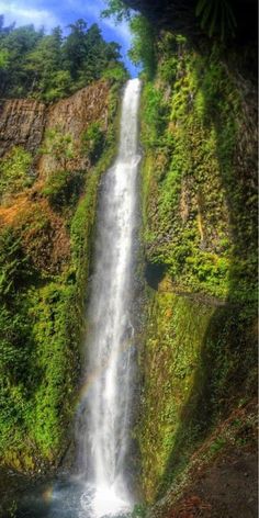 a waterfall with a rainbow in the middle