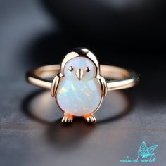 14k Gold Plated Penguin Ring with Ethiopian Opal, Penguin Bowtie Gemstone Ring, Cute Gemstone Penguin Ring, Cute Penguin Jewelry 🌺Item Detail🌺 ♠️ Item Name : Penguin Ring ♠️ Metal : 925 Silver  ♠️ Size : Select the Variations ♠️ Stone : Ethiopian Opal                                                                           🌊 *About Us: Natural World Jewelry* 🐚 At Natural World Jewelry, we're passionate about bringing the serene beauty of the ocean to your everyday life. Our artisanal jewelry pieces are lovingly handcrafted using a diverse array of exquisite shells collected from the world's most breathtaking shorelines. 🐚 *Our Craftsmanship* Each piece of jewelry in our collection is a testament to the unique beauty found in nature. Our skilled artisans carefully select, shape, and p Rose Gold Opal Ring Gift, Rose Gold 14k Opal Ring Gift, Gift White Gold Opal Gemstone Ring, White Gold Opal Gemstone Ring For Gift, Fine Jewelry Opal Ring With Accent Stones As Gift, Opal Ring With Accent Stones As Gift, Opal Jewelry With Accent Stones For Gift, Opal Jewelry With Accent Stones As A Gift, Penguin Ring