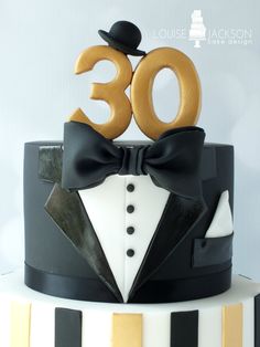 a black and white cake with a bow tie on top