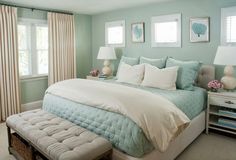 a bedroom with blue walls and white bedding