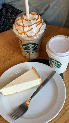 a piece of cake on a plate next to a cup of coffee and a fork