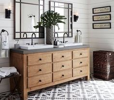 a bathroom with two sinks and mirrors on the wall