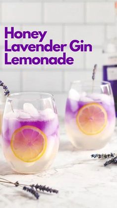 two glasses filled with lemonade sitting on top of a counter next to lavenders