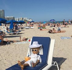 a teddy bear sitting on top of a beach chair