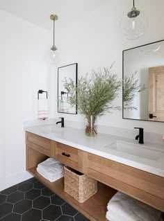 a bathroom with a sink, mirror and towels on the counter in front of it