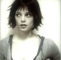 a woman with short hair is posing for the camera