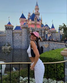 a woman standing in front of a castle