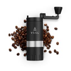 a coffee grinder surrounded by coffee beans on a white background with the word vssl printed on it