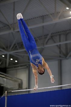 a person on a balance beam doing a handstand