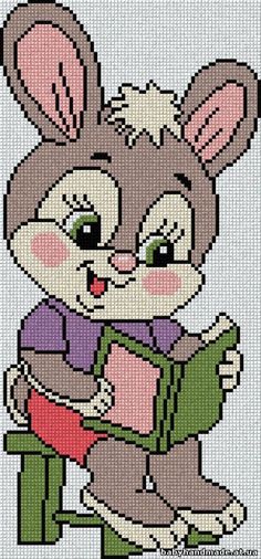 a cross stitch bunny reading a book